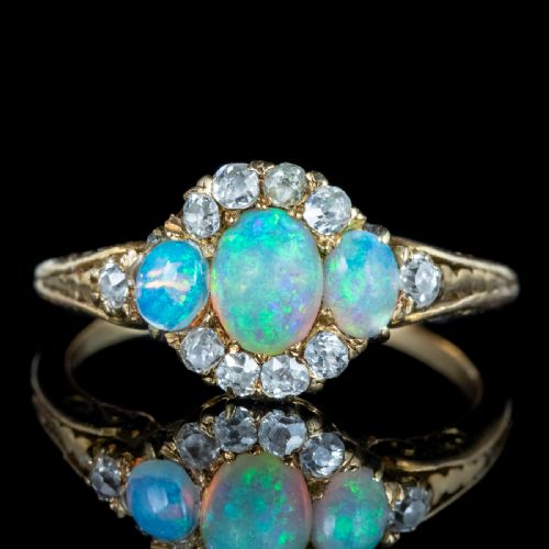 fig 2. A Victorian yellow gold ring set with three oval cabochon opals surrounded by small diamonds.