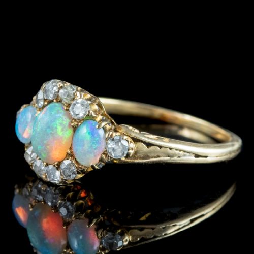 fig 3. A Victorian yellow gold ring set with three oval cabochon opals surrounded by small diamonds.