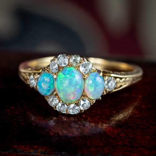 fig 4. A Victorian yellow gold ring set with three oval cabochon opals surrounded by small diamonds.
