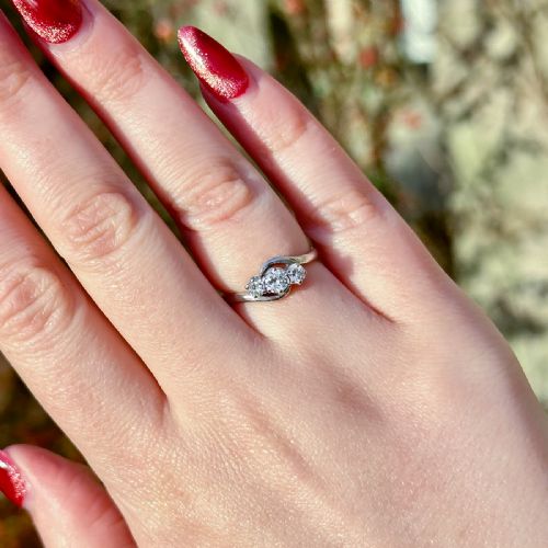fig 1. An Edwardian platinum trilogy ring featuring three round diamonds set in a crossover twist band.