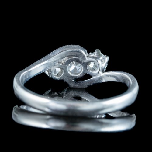 fig 2. An Edwardian platinum trilogy ring featuring three round diamonds set in a crossover twist band.