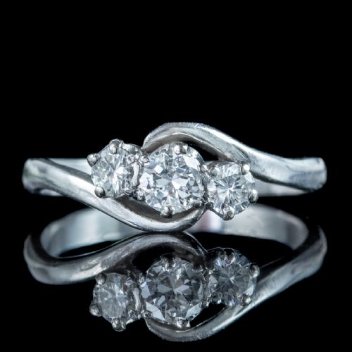 fig 3. An Edwardian platinum trilogy ring featuring three round diamonds set in a crossover twist band.