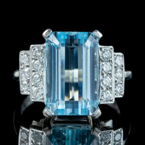 fig 3. A vintage 1950s cocktail ring featuring a large emerald-cut blue aquamarine flanked by stepped shoulders set with round diamonds.