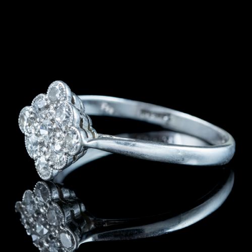 fig 4. An Edwardian diamond cluster ring featuring old cut diamonds set in a milgrain-bordered quatrefoil pattern in platinum.