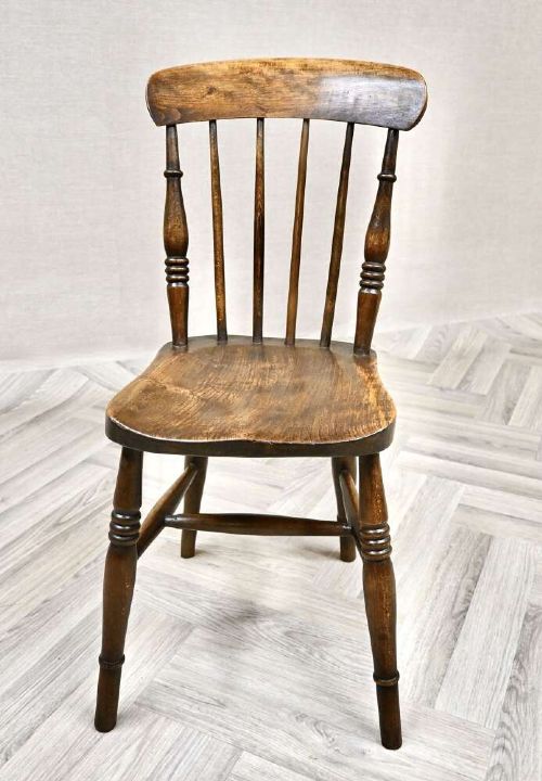 A pair of antique wooden Windsor stickback kitchen chairs featuring curved crest rails, vertical back spindles, shaped seats, and turned legs. View V