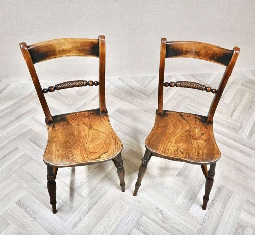 A pair of Victorian wooden kitchen chairs featuring curved top rails, carved rope-twist middle bars, shaped saddle seats, and turned legs. View III