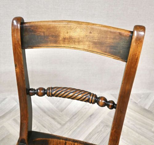 A pair of Victorian wooden kitchen chairs featuring curved top rails, carved rope-twist middle bars, shaped saddle seats, and turned legs. View V