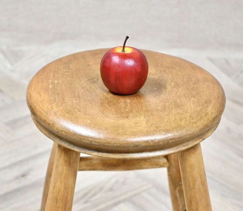 A nineteenth-century round wooden stool featuring four splayed turned legs supported by round stretchers. View IV