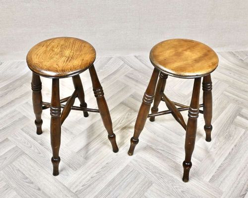 A pair of 19th-century turned wood Windsor stools with round seats, splayed legs, and cross stretchers. View II