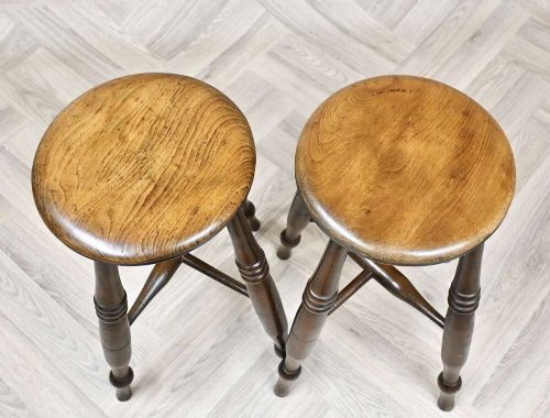 A pair of 19th-century turned wood Windsor stools with round seats, splayed legs, and cross stretchers. View III