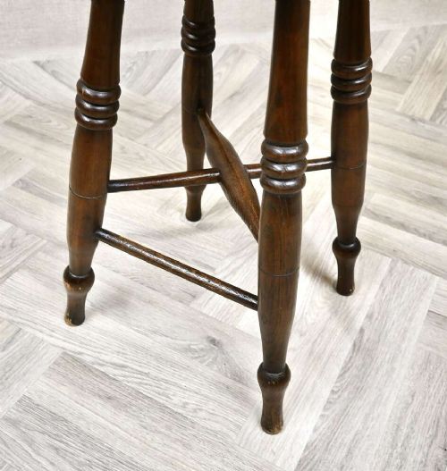 A pair of 19th-century turned wood Windsor stools with round seats, splayed legs, and cross stretchers. View V