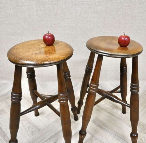 A pair of 19th-century turned wood Windsor stools with round seats, splayed legs, and cross stretchers. View VI