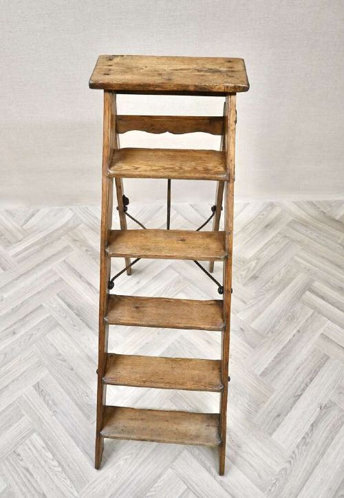 A vintage pine A-frame step ladder featuring wooden treads, iron side braces, and a top platform. View III