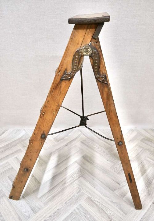 A vintage pine A-frame step ladder featuring wooden treads, iron side braces, and a top platform. View IV