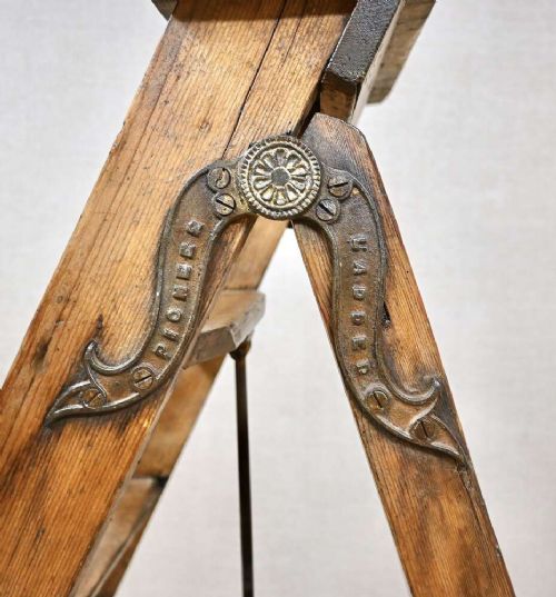 A vintage pine A-frame step ladder featuring wooden treads, iron side braces, and a top platform. View V