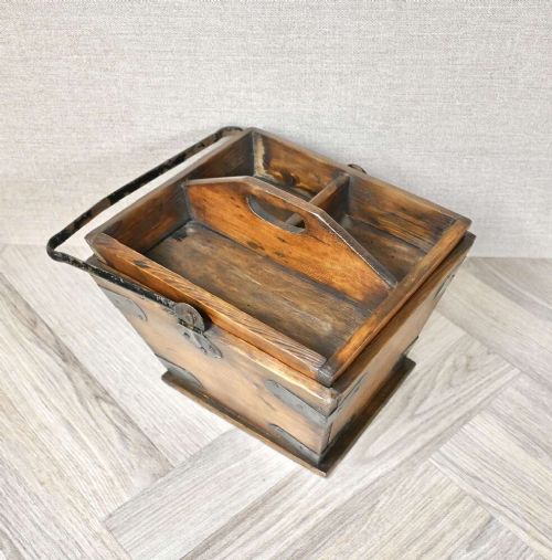 A tapered rectangular wooden housekeepers bucket with iron corner brackets, internal dividers, and a tall metal swing handle. View III