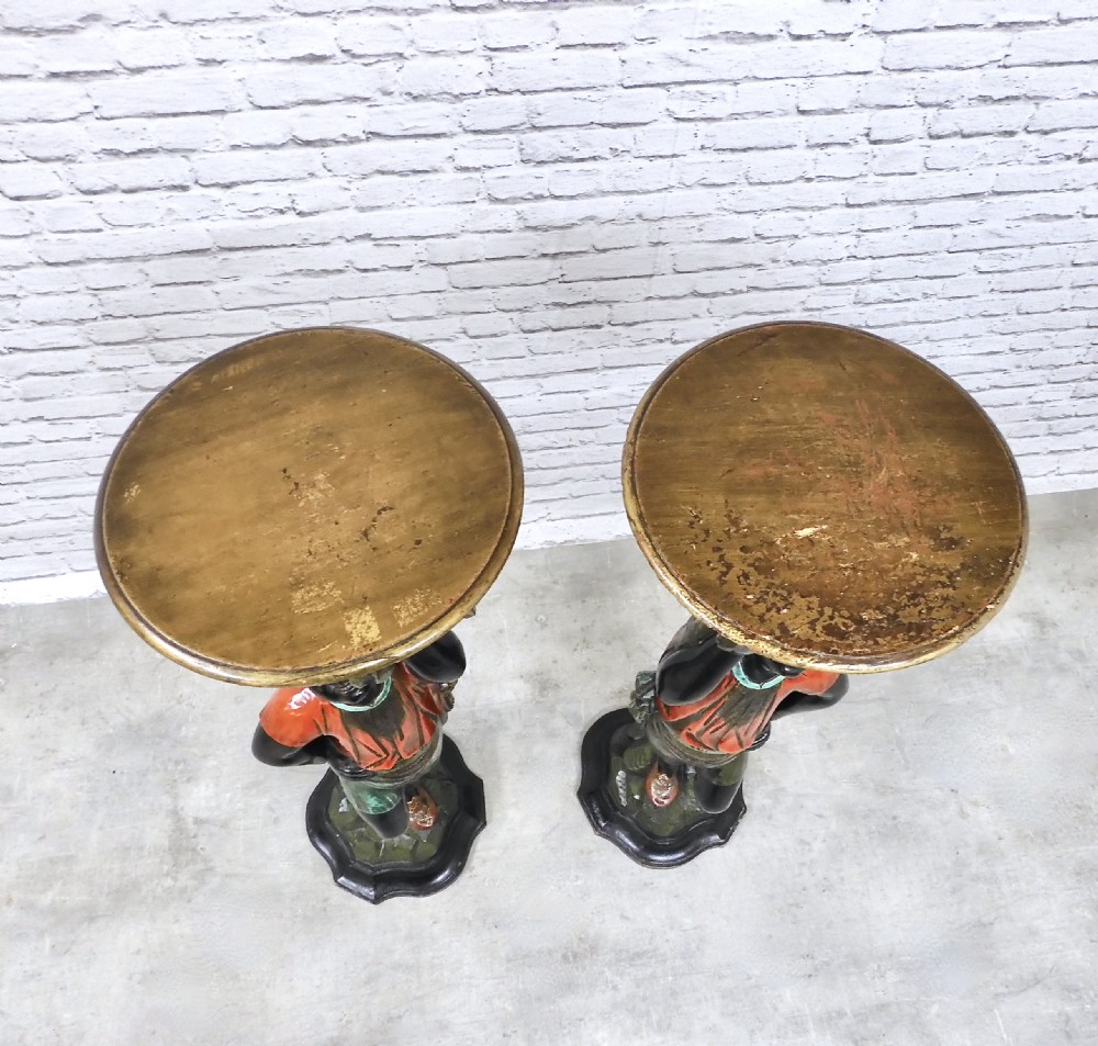 A pair of carved polychrome Venetian Blackamoor pedestals featuring standing figures supporting circular tabletops. View XI