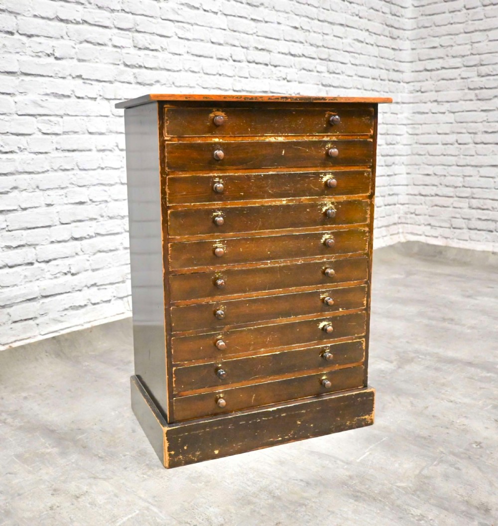 A tall nineteenth-century dark brown wooden specimen chest featuring ten shallow drawers with dual turned wooden knobs and a solid plinth base. View II