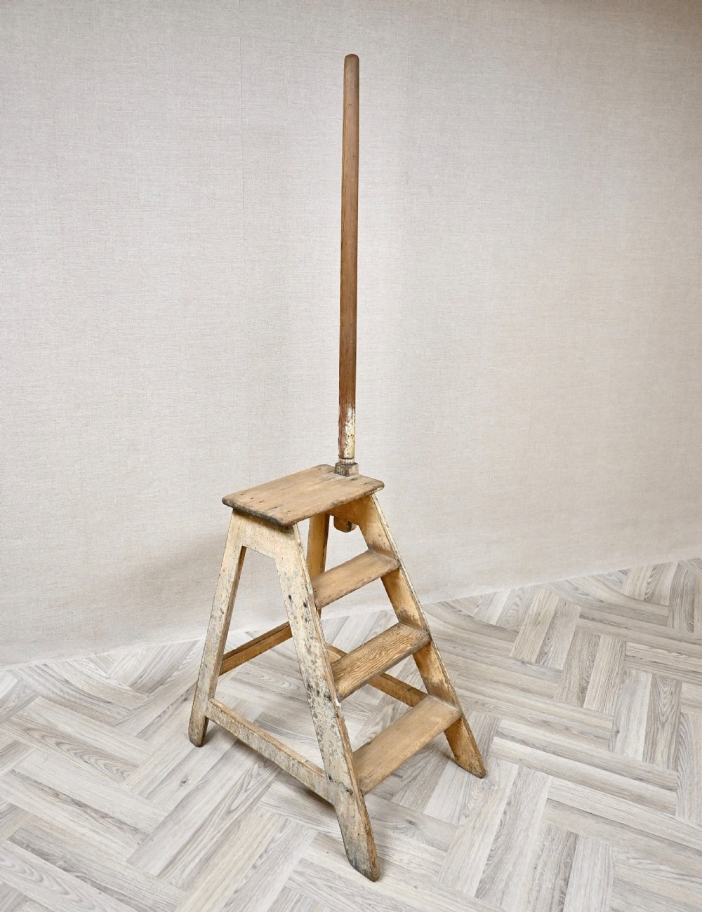 Light pine wooden step ladder featuring an extended vertical handrail pole and hand-painted black lettering along the side frame. View III