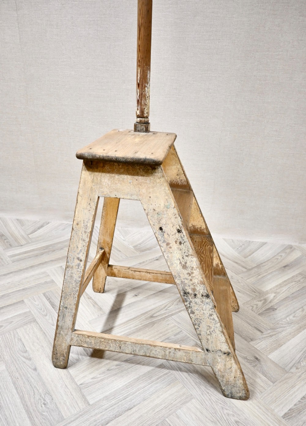Light pine wooden step ladder featuring an extended vertical handrail pole and hand-painted black lettering along the side frame. View IV