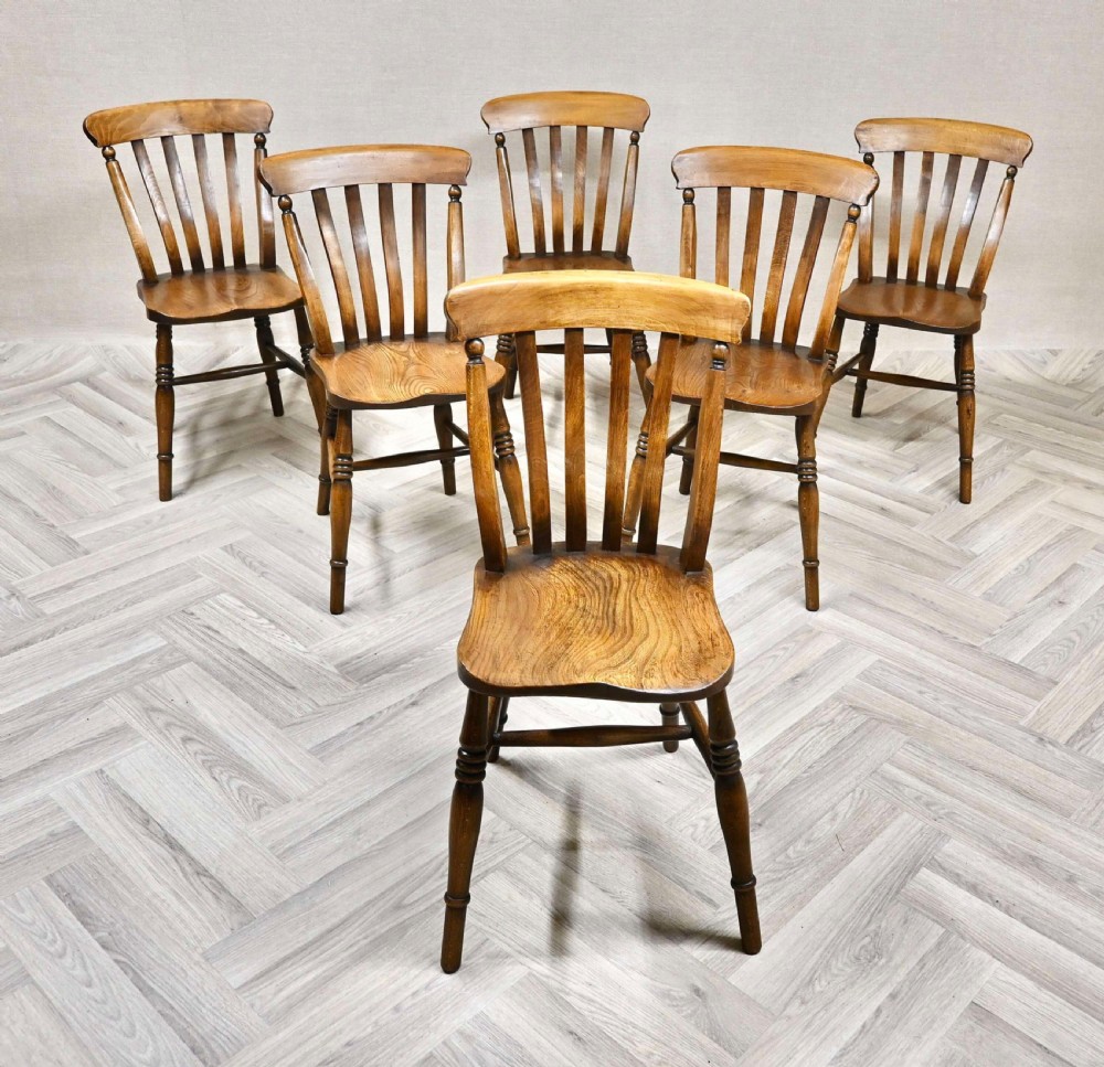 A set of six matching wooden Windsor kitchen dining chairs with shaped seats, vertical back slats, turned legs, and cross stretchers. View VI