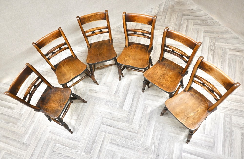 A set of six matching antique wooden Windsor barback dining chairs featuring turned legs, horizontal back rails with central bobbin detail, and contoured wooden seats. View III
