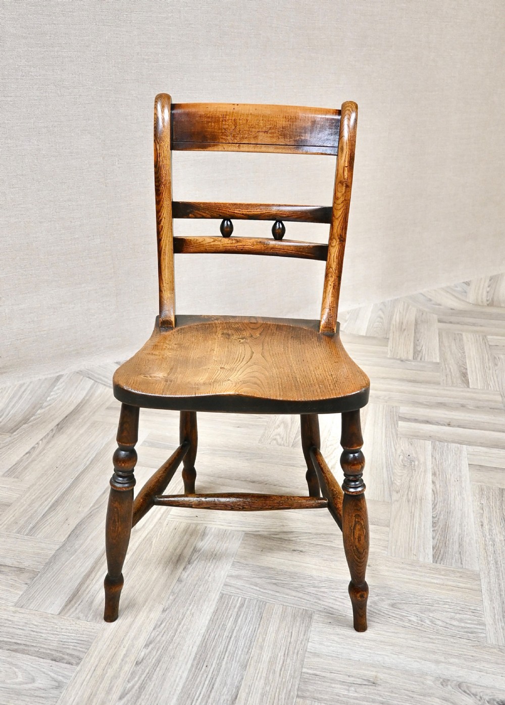 A set of six matching antique wooden Windsor barback dining chairs featuring turned legs, horizontal back rails with central bobbin detail, and contoured wooden seats. View V