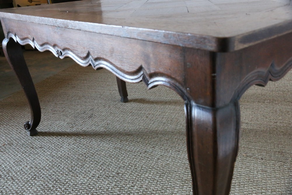 A rectangular dark oak table featuring an inlaid parquet pattern top, a scalloped apron, and sweeping cabriole legs with scroll feet. View V