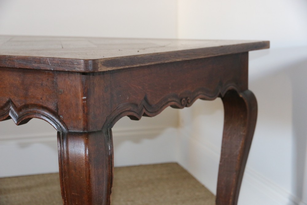 A rectangular dark oak table featuring an inlaid parquet pattern top, a scalloped apron, and sweeping cabriole legs with scroll feet. View VI