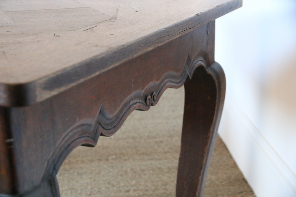 A rectangular dark oak table featuring an inlaid parquet pattern top, a scalloped apron, and sweeping cabriole legs with scroll feet. View XI