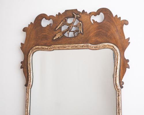fig 2. A George II style walnut fretwork pier mirror featuring a carved parcel-gilt hoho bird motif on the crest and a gilded inner moulding.