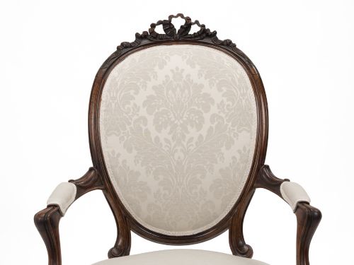 fig 2. A pair of mid-19th century English rosewood Rococo Revival open armchairs with oval damask backs, carved top crests, padded arms, and cabriole legs on castors.