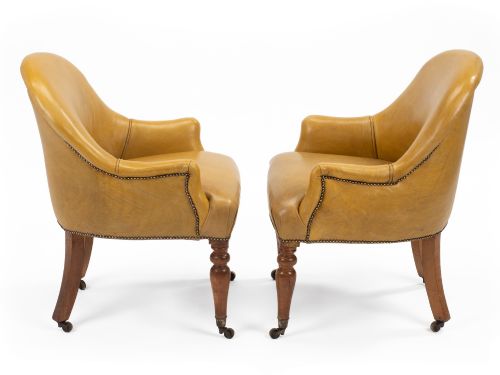 fig 3. A pair of early 19th-century Regency library armchairs upholstered in warm tan leather with turned maple front legs on brass castors.