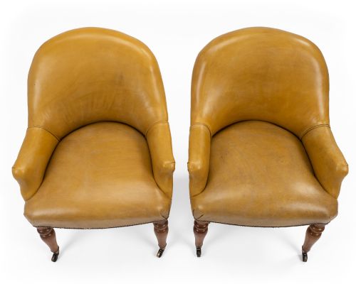 fig 4. A pair of early 19th-century Regency library armchairs upholstered in warm tan leather with turned maple front legs on brass castors.