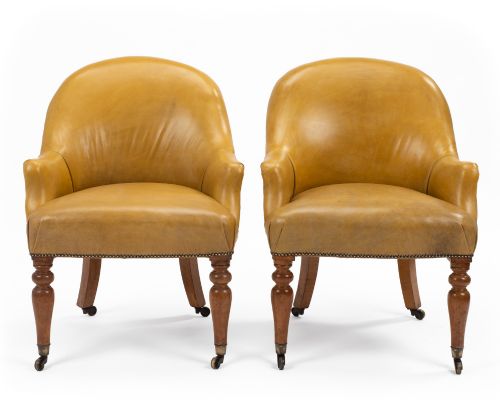 fig 5. A pair of early 19th-century Regency library armchairs upholstered in warm tan leather with turned maple front legs on brass castors.