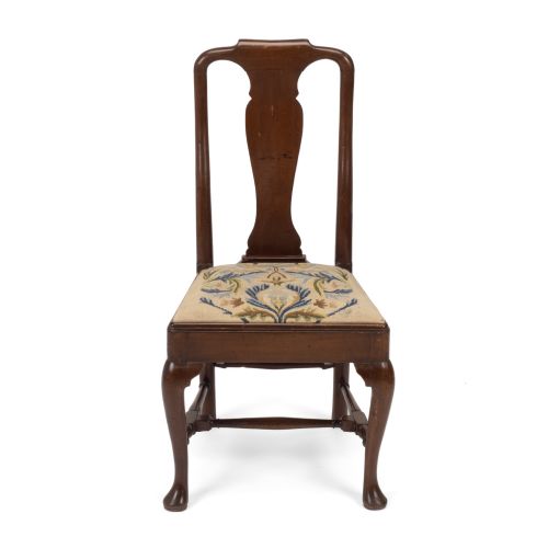 fig 1. A George II walnut side chair featuring a shaped vasiform splat, cabriole front legs with pad feet, turned stretchers, and a floral needlework drop-in seat.