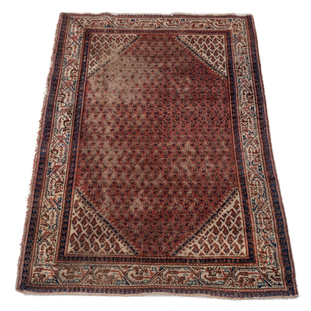 A rectangular late 19th-century handwoven Persian Mir Seraband rug featuring a repeating boteh pattern in terracotta red, blue, and cream.