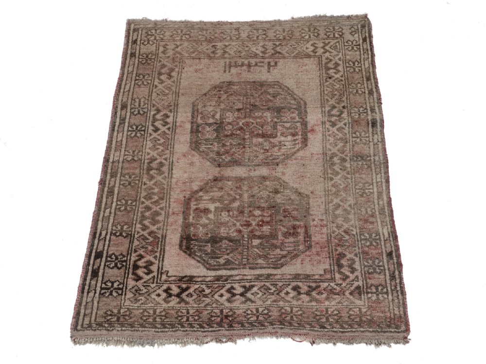 A small rectangular hand-knotted wool rug featuring two central octagonal gul medallions on a faded pink and beige ground with geometric borders. View III