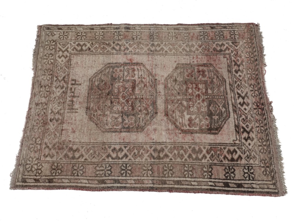 A small rectangular hand-knotted wool rug featuring two central octagonal gul medallions on a faded pink and beige ground with geometric borders. View IV