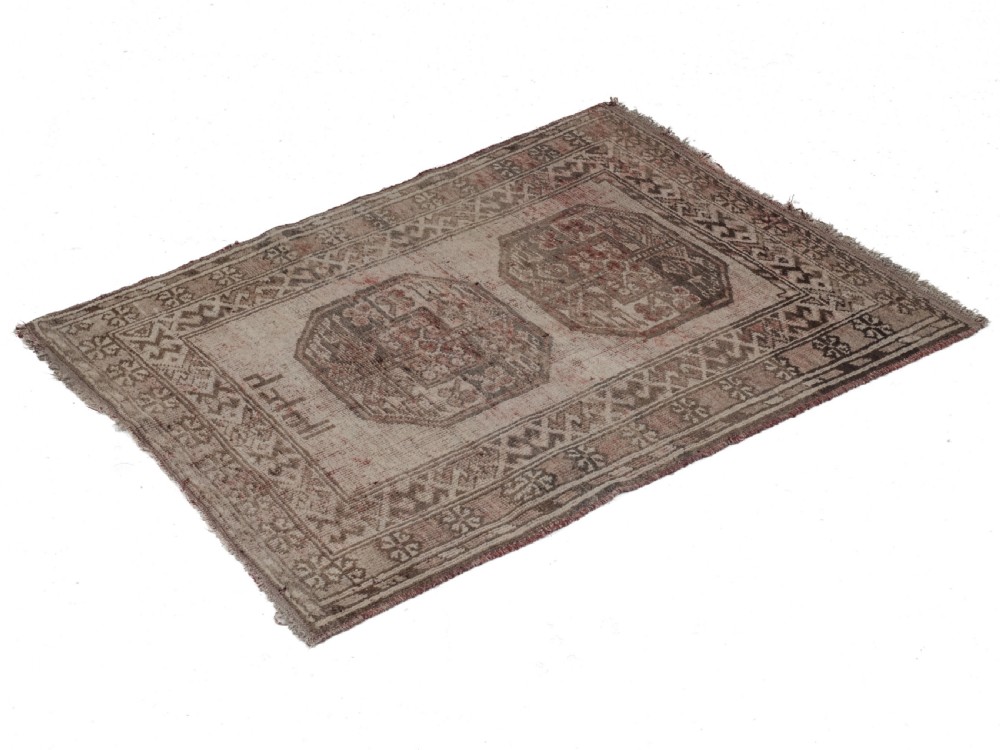 A small rectangular hand-knotted wool rug featuring two central octagonal gul medallions on a faded pink and beige ground with geometric borders. View V