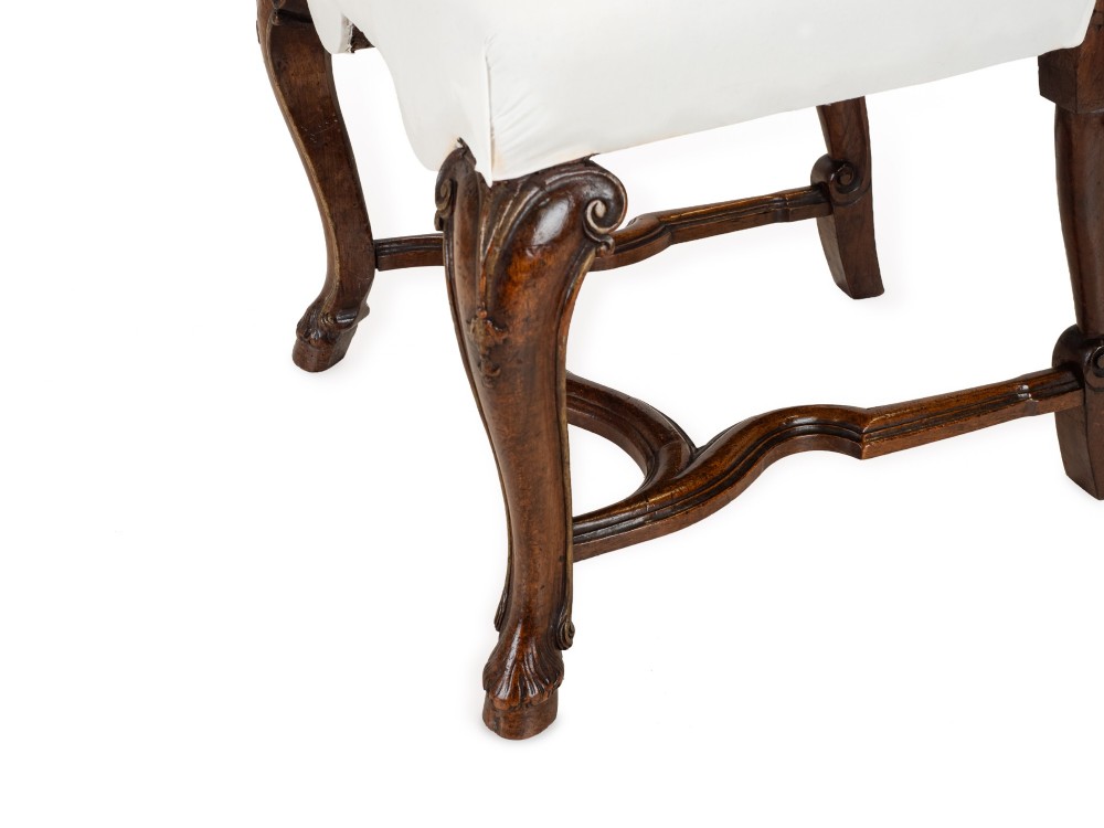 A set of six tall carved walnut dining chairs featuring gilt highlights, pierced splats, and white fabric drop-in seats. View X