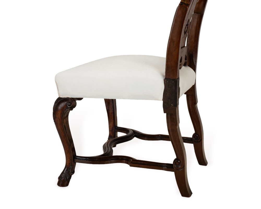 A set of six tall carved walnut dining chairs featuring gilt highlights, pierced splats, and white fabric drop-in seats. View XIII