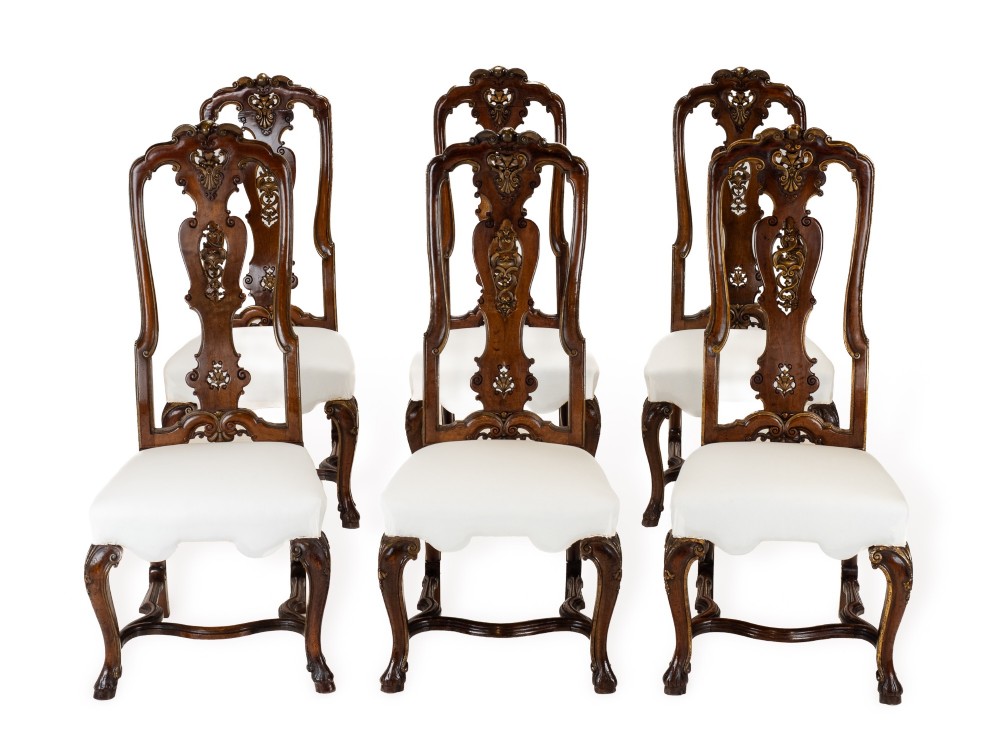 A set of six tall carved walnut dining chairs featuring gilt highlights, pierced splats, and white fabric drop-in seats. View XIV