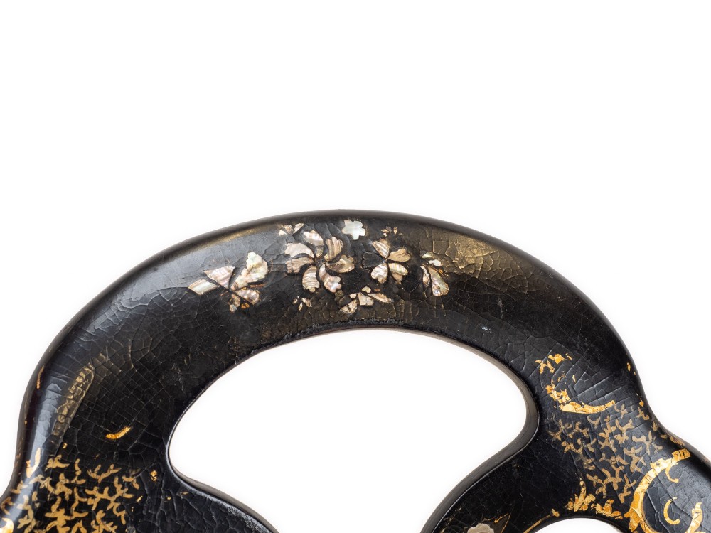 A black japanned papier-mache side chair with mother-of-pearl floral inlay, gold leaf flourishes, a openwork backrest, cabriole front legs, and a woven cane seat. View VI