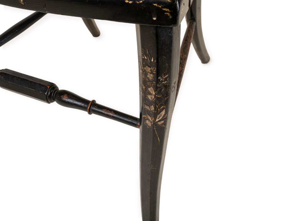 A black japanned papier-mache side chair with mother-of-pearl floral inlay, gold leaf flourishes, a openwork backrest, cabriole front legs, and a woven cane seat. View X