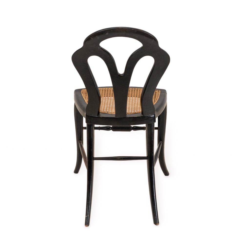 A black japanned papier-mache side chair with mother-of-pearl floral inlay, gold leaf flourishes, a openwork backrest, cabriole front legs, and a woven cane seat. View XIII