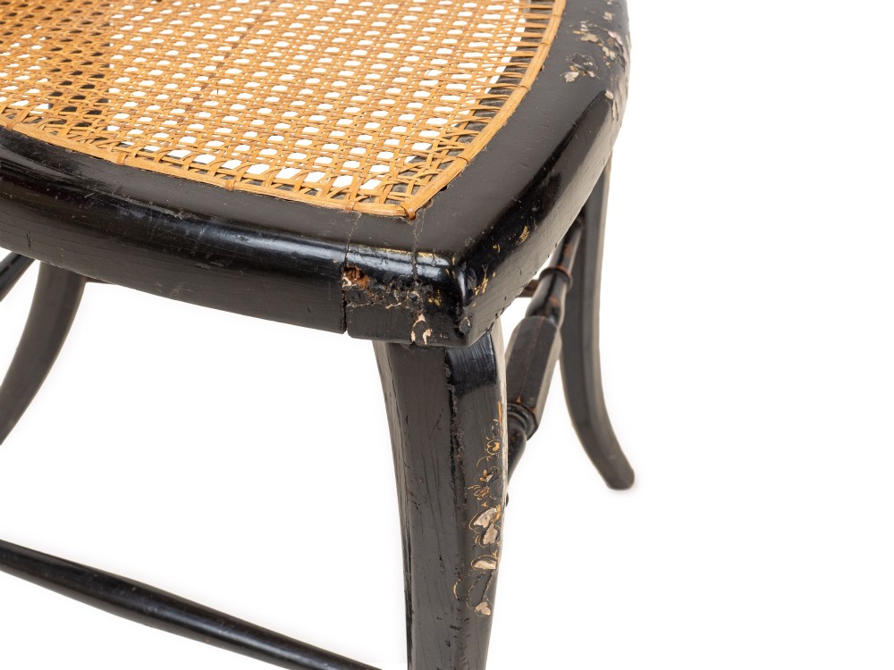 A black japanned papier-mache side chair with mother-of-pearl floral inlay, gold leaf flourishes, a openwork backrest, cabriole front legs, and a woven cane seat. View XIV