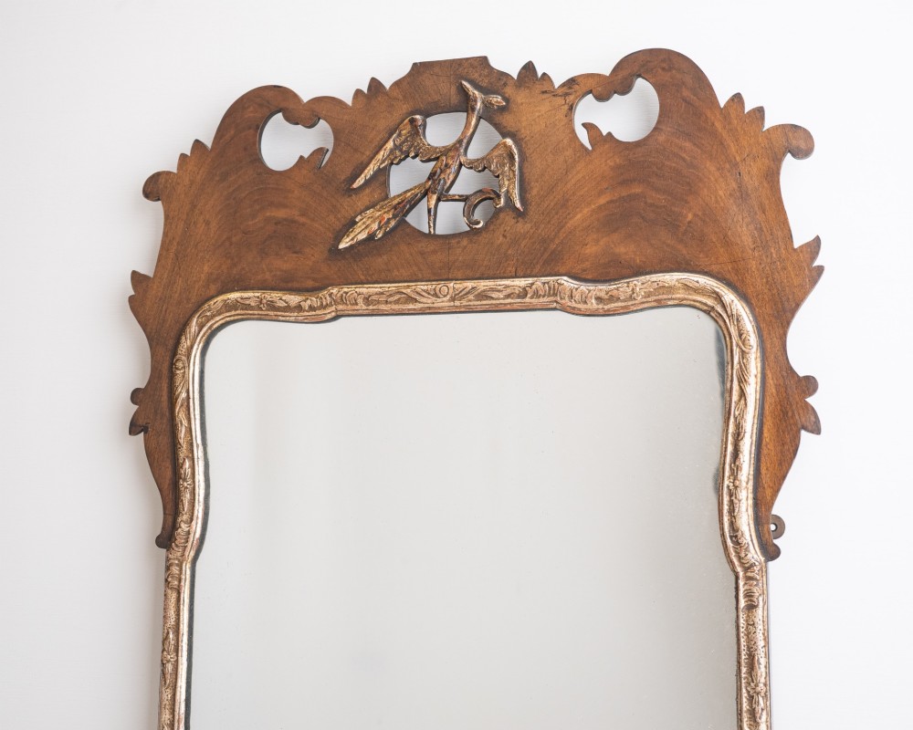 A George II style walnut fretwork pier mirror featuring a carved parcel-gilt hoho bird motif on the crest and a gilded inner moulding. View III