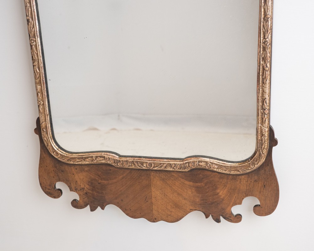A George II style walnut fretwork pier mirror featuring a carved parcel-gilt hoho bird motif on the crest and a gilded inner moulding. View IV
