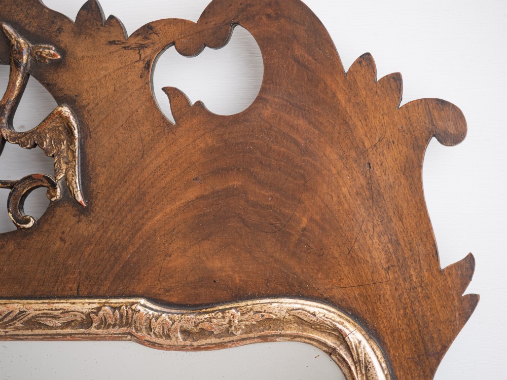 A George II style walnut fretwork pier mirror featuring a carved parcel-gilt hoho bird motif on the crest and a gilded inner moulding. View VII